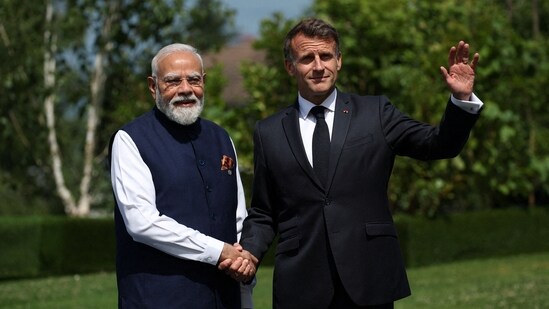 France's President Emmanuel Macron (R) shakes hands with India's Prime Minister Narendra Modi before a family photograph during the G7 summit, in Evian, eastern France, on June 16, 2026. A G7 summit is set to take place June 15 to 17 in the French town of Evian-les-Bains near Switzerland and it will be attended by country leaders as well as the EU's foreign policy chief and ministers from Brazil, Canada, the United Arab Emirates and Turkey.&nbsp;(AFP)