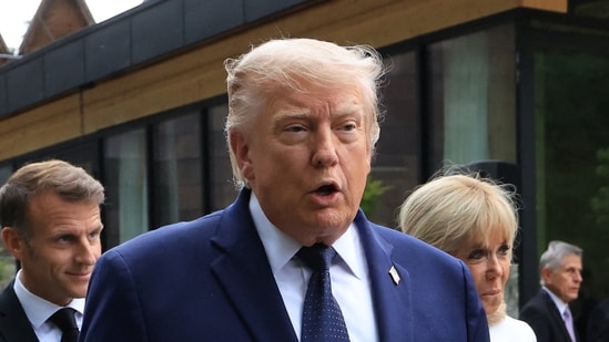 US President Donald Trump, France's President Emmanuel Macron with his wife Brigitte walk before  a family photo photograph prior to a gala dinner as part of the G7 summit in Evian-les-Bains, France.
