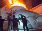 A passenger, top, jumps out of a plane after it crashed on a highway as other people help Tuesday, June 16, 2026, in Laredo, Texas. (Zayra Garza via AP)