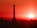 The sun rises by the Eiffel Tower and the Sacre Coeur Basilica ontop of the Montmartre hill in Paris. (Representative photo/AFP)