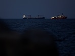 A container ship and survey vessel in the Strait of Hormuz, off Muscat, Oman.