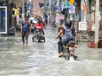 People wade through flooded water near Wazirabad Colony in New Delhi on September 06, 2025. Anita Nair’s Why I Killed My Husband is inspired by contemporary issues and has stories that touch on everything from demonetisation to farmers’ agitations, CAA protests and urban floods. (RAJ K RAJ /HT PHOTO)