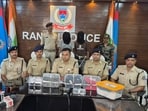 Police with two of the accused in the RSS office bomb attack case in Ranchi on Thursday. (HT Photo)