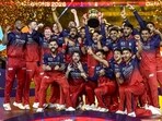 Royal Challengers Bengaluru's players celebrate with the trophy after winning IPL 2026. (PTI)