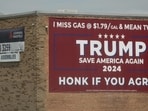 A 2024 campaign sign for President Donald Trump, touting low gas prices, greets motorists along Interstate 90 on May 21, 2026 in Arlington Heights, Illinois. 