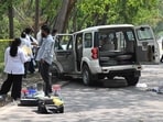 A forensics team at the encounter spot near Dhanas forest area behind Panjab University in Chandigarh on Thursday. (Keshav Singh/HT)
