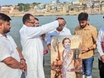 Congress workers with a portrait of Rahul Gandhi dressed as Lord Parashuram on the occasion of his birthday, at the bank of the river Ganga, in Varanasi on Friday. 