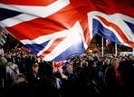 FILE PHOTO: A man waves a Union Jack flag on Brexit day in London, Britain, January 31, 2020. 
