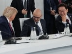 U.S. President Donald Trump talks to CEO of Google DeepMind Demis Hassabis, center, and South Korea's President Lee Jae Myung during the G7 summit.