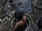 NEW DELHI, INDIA - SEPTEMBER 18,2013: municipal worker attempts to unblock a sewer overflowing with human excreta in New Delhi on October 7, 2009. Although a law bans manual scavenging - the manual removal of human excreta from 'dry toilets' - the practice is widespread across cities and towns in India. (Photograph by Raj K Raj / Hindustan Times)