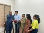 Noor Singla celebrating his achievement with his family in Patiala on Thursday. (HT)