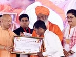 Uttar Pradesh chief minister Yogi Adityanath at a public event in Unnao on Thursday. (ANI PHOTO)