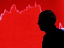 FILE PHOTO: FILE PHOTO: A man looks at a screen displaying news of markets update inside the Bombay Stock Exchange building in Mumbai, India, February 11, 2016. REUTERS/Danish Siddiqui/File Photo/File Photo