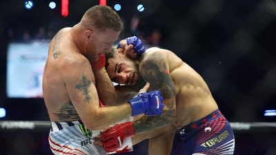 Jun 14, 2026; Washington, D.C., UNITED STATES; Ilia Topuria (red gloves) fights Justin Gaethje (blue gloves) during UFC Freedom 250 at White House South Lawn. Mandatory Credit: Amber Searls-Imagn Images (IMAGN IMAGES via Reuters Connect)