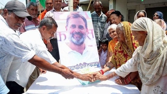 Congress party workers cut a cake to celebrate the 56th birthday of Lok Sabha LoP and Congress leader Rahul Gandhi, in Bhopal on Friday. (ANI Photo)