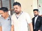 Suspended IAS officer Ram Kumar Singh (in grey shirt) being produced in a local court on Friday. (HT Photo)