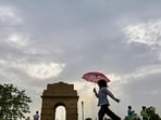 Gram it: Sunny skies make way for clouds as tourists visit the India Gate this weekend. Making the most of the pleasant weather is a young child who walks with a spring in her step while waiting for the monsoon to grace Delhi.  