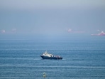 Cargo ships are pictured off cost of the Khor Fakkan Container Terminal along the Gulf of Oman on June 19, 2026. 