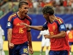 Spain's Lamine Yamal celebrates with teammate Rodri, left, after scoring his side's opening goal during the World Cup Group H soccer match