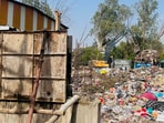 An incomplete boundary wall at the MCG Beriwala Bagh secondary garbage collection point on the NH-48 service road near Mini Secretariat, seen on June 10. (Parveen Kumar/HT)