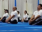 Union defence minister Rajnath Singh, Meghalaya CM Conrad K Sangma and top officials of the IAF join together to commemorate International Yoga Day at Eastern Air Command Shillong (HT Sourced Photo)