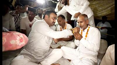 Former president of Haryana Sarpanch Association Somesh Kumar offers juice to elderly protesters, bringing their hunger strike to an end in Hansi, on Sunday. (Manoj Dhaka/HT) Former president of Haryana Sarpanch Association Somesh Kumar offers juice to elderly protesters, bringing their hunger strike to an end in Hansi, on Sunday. (Manoj Dhaka/HT)