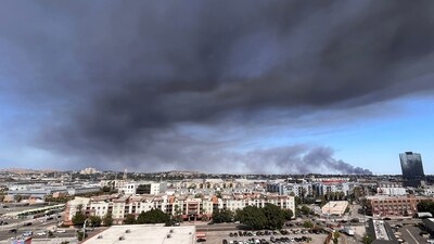Black smoke rises from a warehouse fire in Boyle Heights as seen from downtown Los Angeles on June 17, 2026.(Photo by Etienne LAURENT / AFP) (AFP) Black smoke rises from a warehouse fire in Boyle Heights as seen from downtown Los Angeles on June 17, 2026.(Photo by Etienne LAURENT / AFP) (AFP)