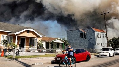 A person rides a bicycle as a massive warehouse fire at a cold storage facility continues to burn and spread smoke around the city on June 20, 2026 in Los Angeles, California. California Governor Gavin Newsom declared a state of emergency today for Los Angeles County in response to the Lineage Logistics warehouse fire which began June 17 in the Boyle Heights neighborhood. (Photo by MARIO TAMA / GETTY IMAGES NORTH AMERICA / Getty Images via AFP) (Getty Images via AFP) A person rides a bicycle as a massive warehouse fire at a cold storage facility continues to burn and spread smoke around the city on June 20, 2026 in Los Angeles, California. California Governor Gavin Newsom declared a state of emergency today for Los Angeles County in response to the Lineage Logistics warehouse fire which began June 17 in the Boyle Heights neighborhood. (Photo by MARIO TAMA / GETTY IMAGES NORTH AMERICA / Getty Images via AFP) (Getty Images via AFP)