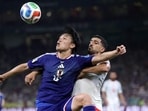 Japan's forward #18 Ayase Ueda and Tunisia's defender #21 Mohamed Ben Hamida vie for the ball during their World Cup game. (AFP)