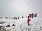 People gather at a snow site at Baralacha Pass, in Lahaul and Spiti district, on Monday. (PTI)