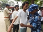 Security personnel checking aspirants before appearing in the NEET examination at the Magadh Mahila College in Patna on Sunday. (Santosh Kumar/HT)