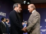 Iran's Foreign Minister Abbas Araghchi (L) shakes hands with Pakistan's Prime Minister Shehbaz Sharif ahead of a quadrilateral meeting between the United States, Iran, Pakistan and Qatar at the Burgenstock.
