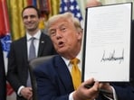 President Donald Trump holds up a signed executive order about quantum computing, in the Oval Office of the White House. President Donald Trump holds up a signed executive order about quantum computing, in the Oval Office of the White House.