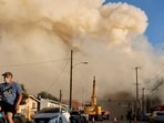 Smoke rises from the Boyle Heights warehouse fire as it burns into its sixth day in Los Angeles.