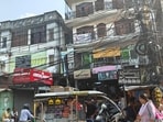 A commercial complex with electricity wires hanging dangerously close, in Lucknow, on Tuesday (HT Photo)