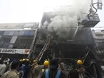 As the blaze spread, thick smoke choked the lone entry and exit point, trapping people inside.