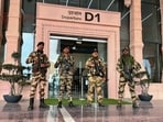 CISF personnel stand guard outside an airport.