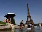 People cool off in the Trocadero fountain in front of the Eiffel Tower as temperatures rise in Paris during a heatwave affecting a large part of France. REUTERS/Abdul Saboor