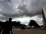 Citizens walks past as Dark Monsoon clouds hover above Kopar Khairane ahead of the start of Monsoon Season, in Navi Mumbai, India,