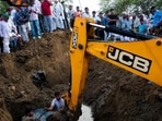 The district administration removing a newly installed six-inch T-joint from the Bhakra drinking water pipeline in Chanot village of Hansi on Tuesday as villagers look on. (HT Photo)