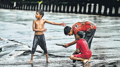 A group of children enjoy the long-awaited showers on Tuesday. The IMD has placed Mumbai under a yellow alert for Wednesday and Thursday, indicating chances of heavy rainfall. (Raju Shinde/HT Photo) A group of children enjoy the long-awaited showers on Tuesday. The IMD has placed Mumbai under a yellow alert for Wednesday and Thursday, indicating chances of heavy rainfall. (Raju Shinde/HT Photo)