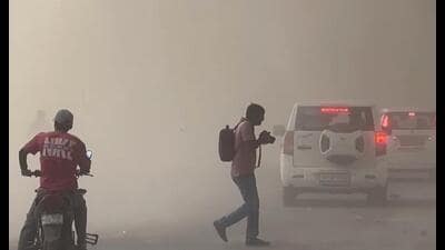 Commuters wade through a heavy dust storm during afternoon hours, in Noida on Tuesday. (ANI Video Grab)