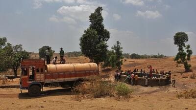 Thane, India - April 24, 2016: Around 80 villages in Shahpur Taluka are facing serious water crisis, who are been provided with the alternative water tankers at present. Villagers of Sidhha Wadi, gathers to fetch the water, after spotting the water tanker filling the well, at Shahpur in thane district. The water tankers have been provided to these villages after every alternate days which are 63 kms long from the Shahpur to Sidhha wadi village, India, on Sunday, April 24, 2016. (Photo by Praful Gangurde/Hindustan Times) Thane, India - April 24, 2016: Around 80 villages in Shahpur Taluka are facing serious water crisis, who are been provided with the alternative water tankers at present. Villagers of Sidhha Wadi, gathers to fetch the water, after spotting the water tanker filling the well, at Shahpur in thane district. The water tankers have been provided to these villages after every alternate days which are 63 kms long from the Shahpur to Sidhha wadi village, India, on Sunday, April 24, 2016. (Photo by Praful Gangurde/Hindustan Times)