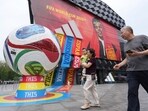Visitors to a mall pass by retail promotion related to the FIFA World Cup in Beijing, China, Wednesday, June 24