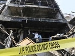 Forensic Science Laboratory (FSL) and Special Investigation Team (SIT) members at the tragedy site for an investigation into the fire in the three-story commercial building in Lucknow’s Aliganj area. (Deepak Gupta/HT Photo)