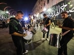 Men beat drums as Iranian Shia Muslims flagellate themselves with chains as part of a mourning ritual during the Islamic month of Muharram, ahead of Ashura, in Tehran late on June 23, 2026. 