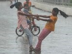 Girls dance in the rain during monsoon shower in Mumbai.