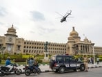 A helicopter flies over the Vidhana Soudha in Bengaluru.