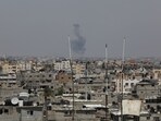 Smoke rises above buildings after air strikes by Israeli warplanes in Gaza City, on May 10, 2023. (Shutterstock)