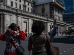 Visitors attempt to keep cool opposite the Bank of England during a heat wave in the City of London, UK, on Wednesday.